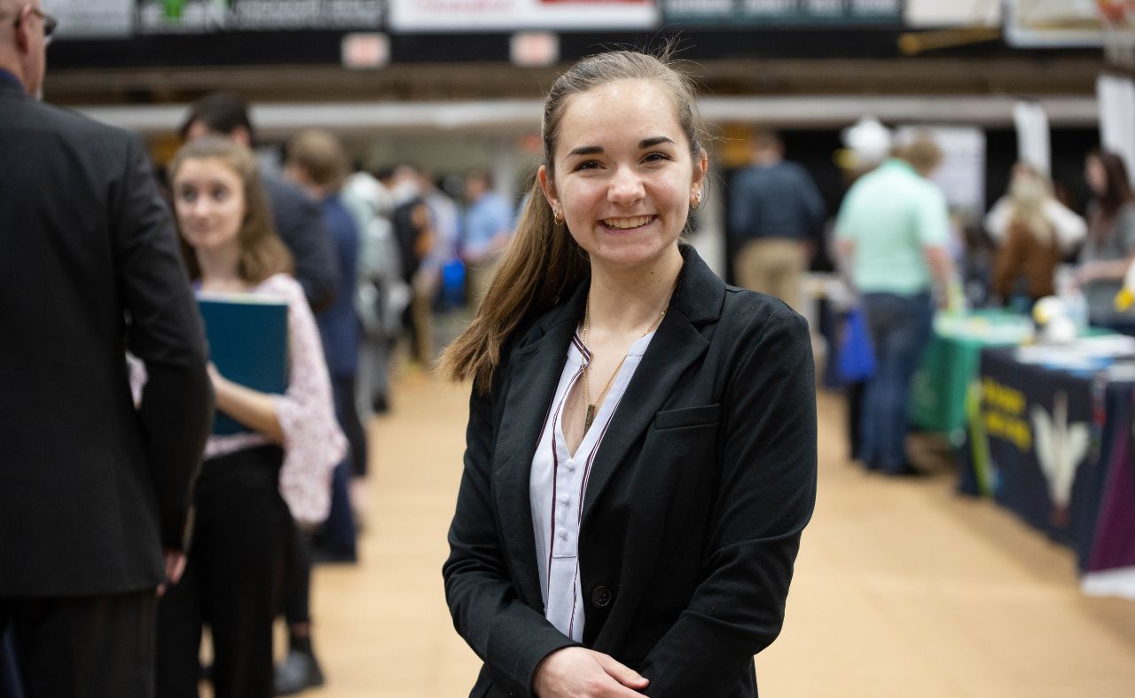 Geneva College student pictured smiling at last year's on-campus career fair.