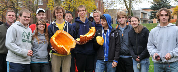 Students involved in exploding the pumpkins at Geneva College.