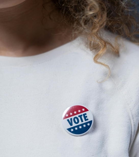 Woman with voting button on her sweatshirt