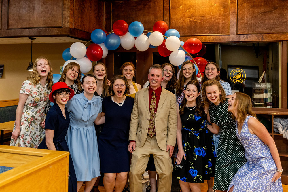 Female students laughing and posing in 1940s era clothes