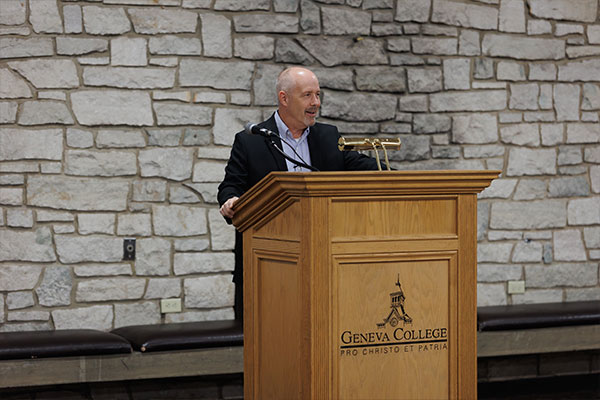 Dr. Spiegel giving a lecture behind a podium