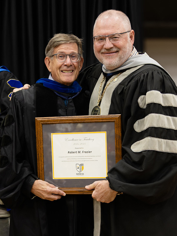 Dr. Bob Frazier receives an award from President Calvin Troup