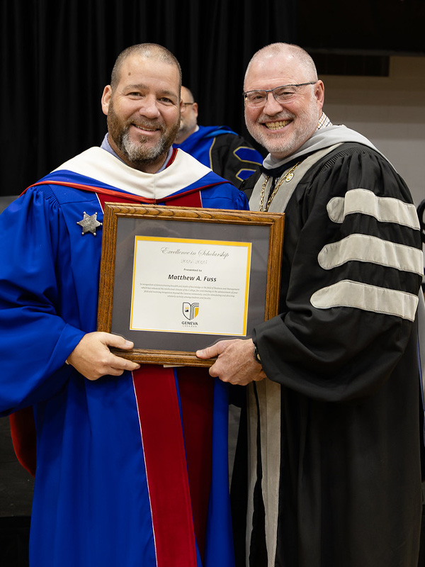 Dr. Matt Fuss receives an award from President Calvin Troup