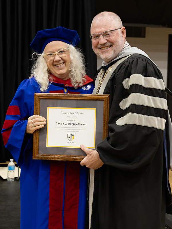 Dr. Denise Murphy-Gerber receives an award from President Calvin Troup