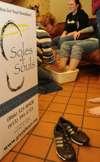 Faculty and staff wash the feet of students who have decided to go barefoot for the day and raise awareness of the fact that many around the world go each day without shoes.