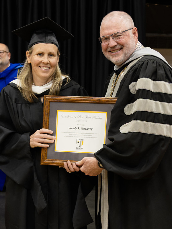 Prof. Wendy Whelpley receives an award from President Calvin Troup