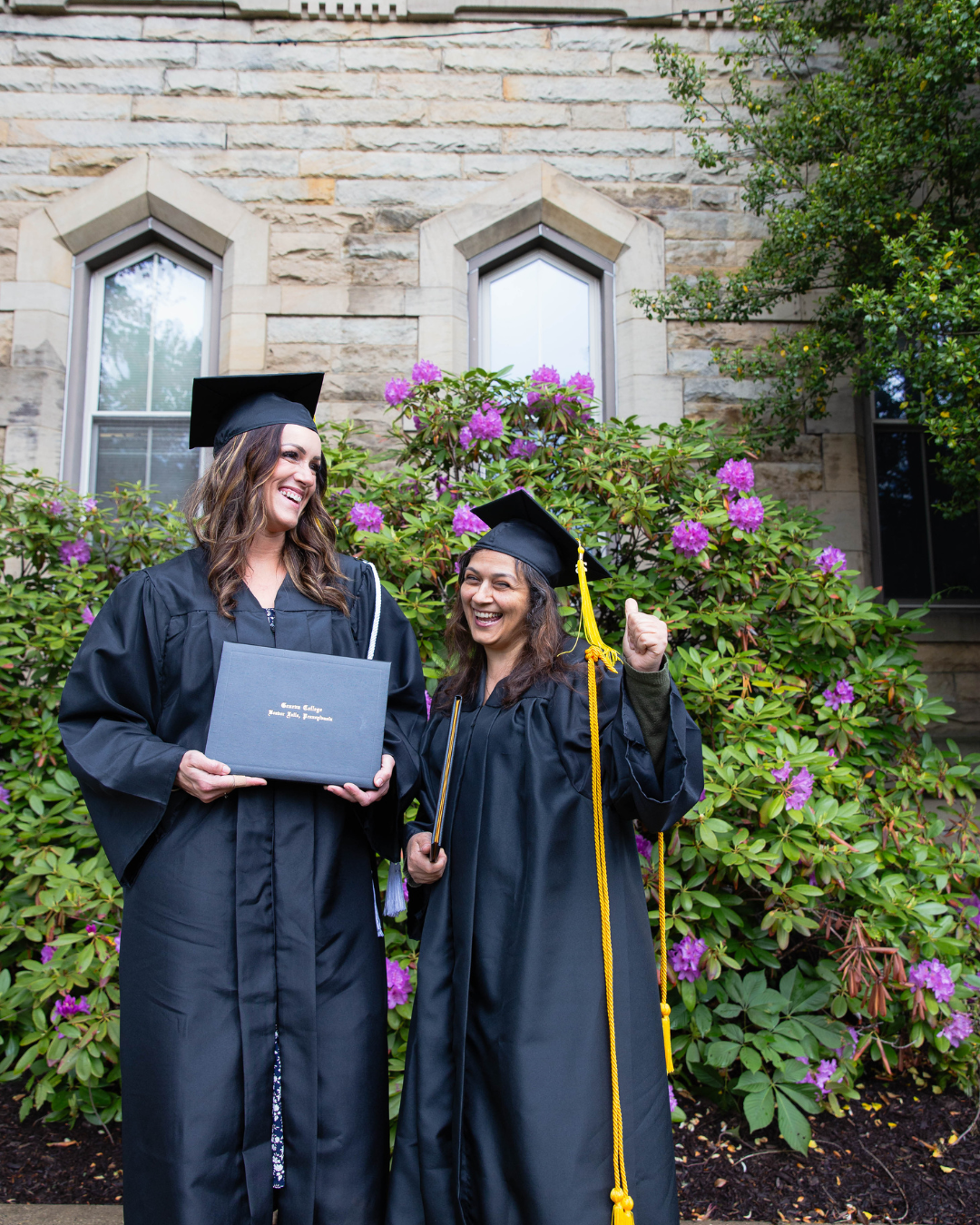 Leah Cochran celebrates graduating with her classmate and friend, Pnina Lizorkin.